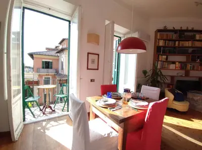 a living room with a wooden table and chairs at La Dimora Torlonia Elegance & light in Rome in Rome