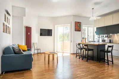 a living room and kitchen with a couch and a table at Cozy flat 2 bedrooms 2 bathrooms with balcony in Rome