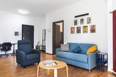 a living room with a blue couch and two chairs at Cozy flat 2 bedrooms 2 bathrooms with balcony in Rome