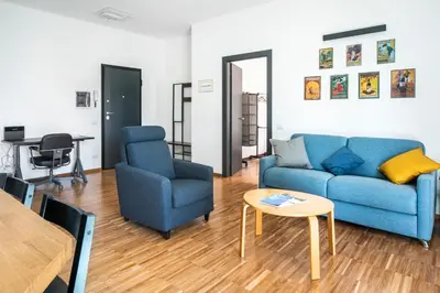 a living room with a blue couch and a table at Cozy flat 2 bedrooms 2 bathrooms with balcony in Rome