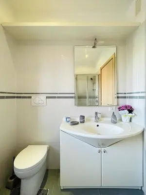a white bathroom with a sink and a toilet at San Peter loft in Rome