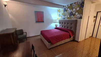 a bedroom with a bed with a red blanket at Hybris Campo De' Fiori in Rome