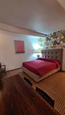a bedroom with a large bed with a red blanket at Hybris Campo De' Fiori in Rome