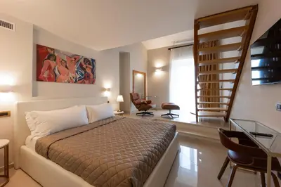 a bedroom with a bed and a staircase in it at Dimora Cardinal Moroni in Rome