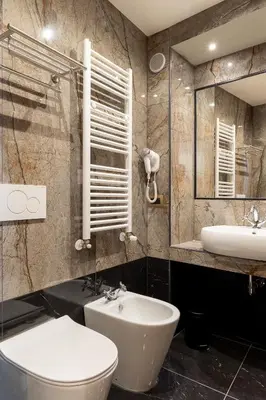 a bathroom with a sink and a toilet and a mirror at Dimora Cardinal Moroni in Rome