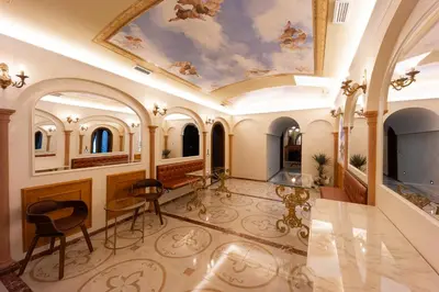 a large room with a ceiling with a painting at Dimora Cardinal Moroni in Rome