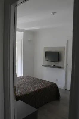 a bedroom with a bed and a flat screen tv at Galileo Luxury Terrace Suites Rome in Rome