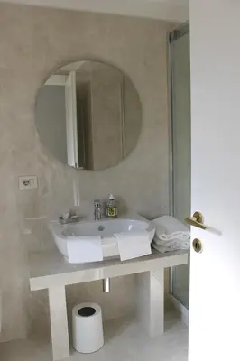 a bathroom with a sink and a mirror at Galileo Luxury Terrace Suites Rome in Rome