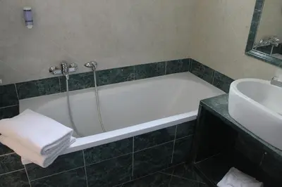 a bathroom with a bath tub and a sink at Galileo Luxury Terrace Suites Rome in Rome