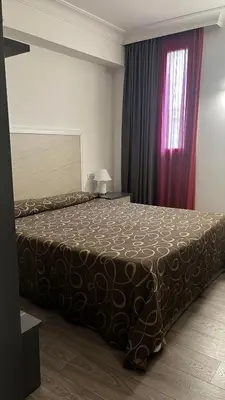a bedroom with a bed with a brown blanket at Galileo Luxury Terrace Suites Rome in Rome