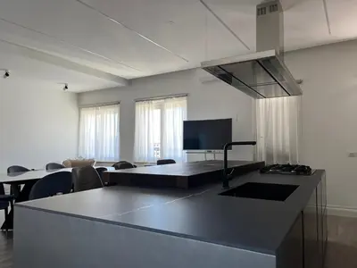 a kitchen with a counter top and a living room at Galileo Luxury Terrace Suites Rome in Rome