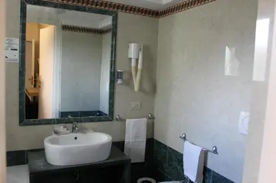 a bathroom with a sink and a mirror at Galileo Luxury Terrace Suites Rome in Rome
