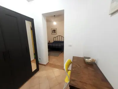 a hallway of a room with a table and chairs at TEVERONE in Rome