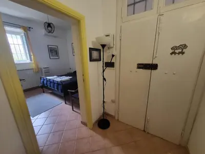 a bedroom with a bed and a yellow door at TEVERONE in Rome