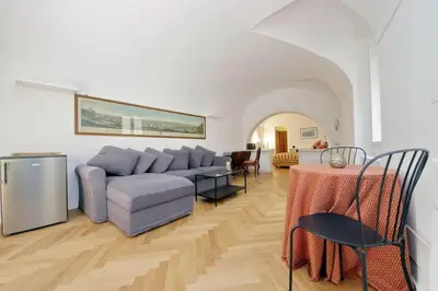 a living room with a couch and a table at Pantheon Apartment with private terrace in Rome