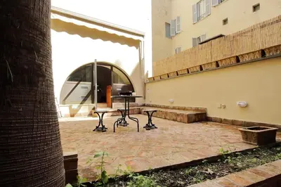 a patio with a table and chairs in a building at Pantheon Apartment with private terrace in Rome