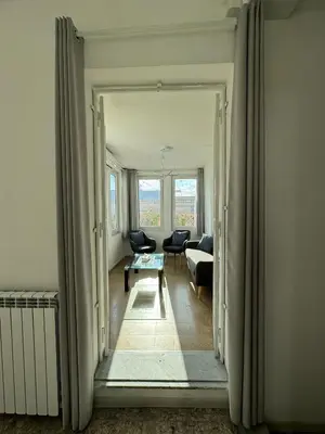 a hallway leading to a living room with a couch at Tristar Terrace Penthouse in Rome