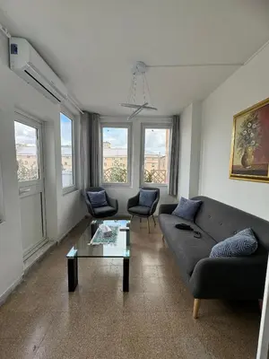a living room with a couch and a table at Tristar Terrace Penthouse in Rome