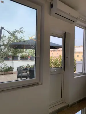 a window in a room with a view of a patio at Tristar Terrace Penthouse in Rome