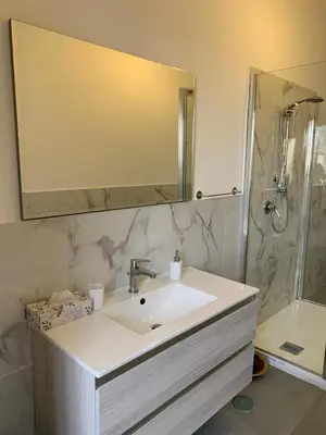 a bathroom with a sink and a large mirror at Tristar Terrace Penthouse in Rome