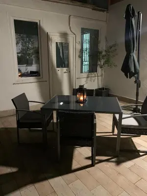 a black table and chairs in a living room at Tristar Terrace Penthouse in Rome
