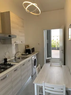 a kitchen with a table and a sink and a stove at Tristar Terrace Penthouse in Rome