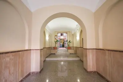 an empty hallway in an old building with an archway at Vatican Apartment - Sister's Place in Rome