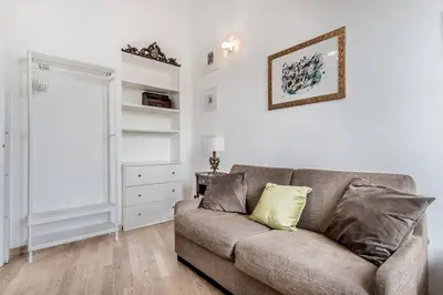 a living room with a couch and a window at Casa Caracciolo Roma Vaticano in Rome