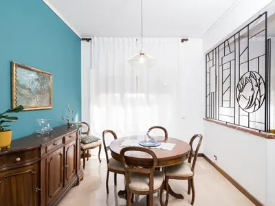 a dining room with a table and chairs at Blessy apartment Vaticano in Rome