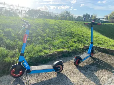 two scooters are parked on the side of a field at Blessy apartment Vaticano in Rome