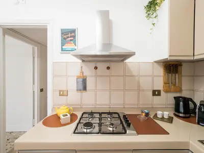 a kitchen with a stove top oven in a kitchen at Blessy apartment Vaticano in Rome