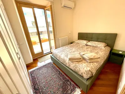 a bedroom with a bed and a large window at Via Umbria 25 Luxury Suites in Rome