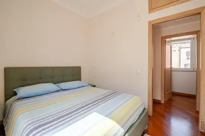 a bedroom with a bed with blue pillows on it at Via Umbria 25 Luxury Suites in Rome