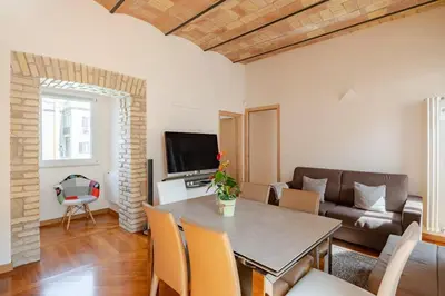 a living room with a table and a couch at Via Umbria 25 Luxury Suites in Rome