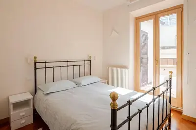 a bedroom with a bed and a large window at Via Umbria 25 Luxury Suites in Rome