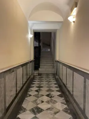 a hallway with a tile floor and stairs in a building at Elian Apartament In The Center of Rome #2 in Rome