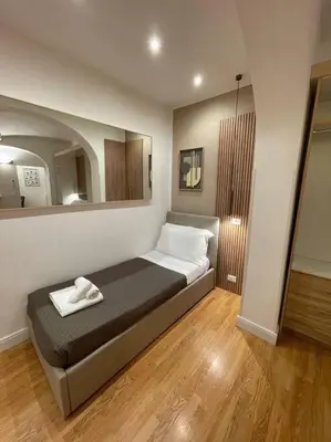 a bedroom with a bed and a large mirror at Elian Apartament In The Center of Rome #2 in Rome