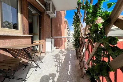 a patio with a table and a bench on a building at La Casa di Roma in Rome