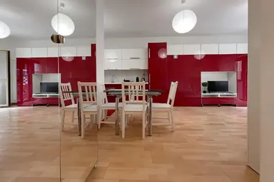 a dining room with red walls and a table and chairs at La Casa di Roma in Rome