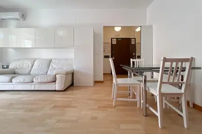 a living room with a couch and a table and chairs at La Casa di Roma in Rome