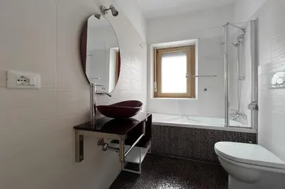 a bathroom with a sink and a mirror and a tub at La Casa di Roma in Rome