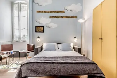 a bedroom with a bed with clouds on the wall at Vatican Blue Sky in Rome