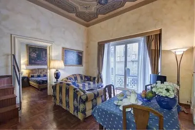 a living room with a couch and a table at Parione Suite Piazza Navona in Rome