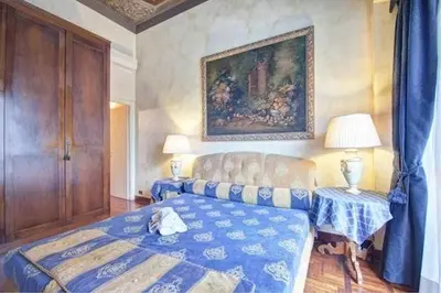 a bedroom with a bed and a painting on the wall at Parione Suite Piazza Navona in Rome