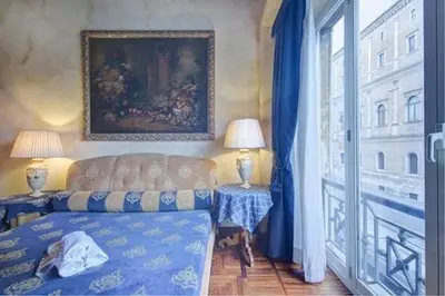 a bedroom with a bed and a large window at Parione Suite Piazza Navona in Rome