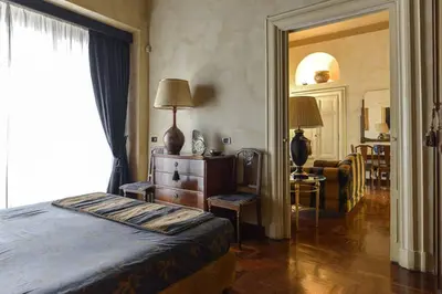 a bedroom with a bed and a table and a chair at Parione Suite Piazza Navona in Rome