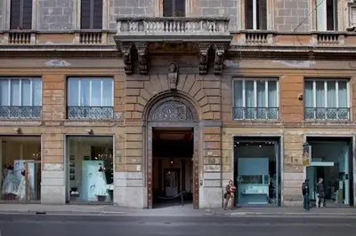 a building on a street with people standing outside of it at Parione Suite Piazza Navona in Rome