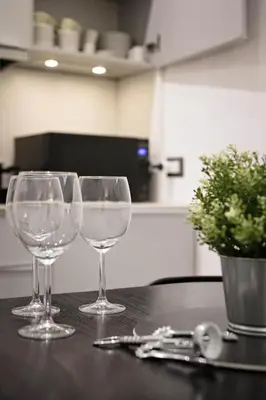 four wine glasses sitting on top of a table at Navona Comfort House in Rome