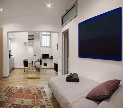 a bedroom with a bed and a large painting on the wall at Navona Comfort House in Rome