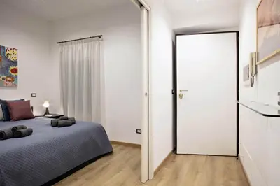 a bedroom with a bed and a large mirror at Navona Comfort House in Rome